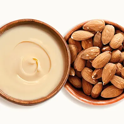 Almond spread with almonds in a plate